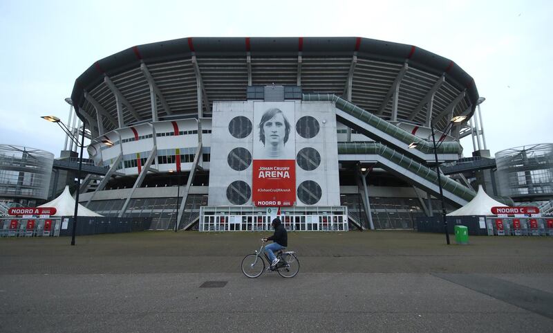 AMSTERDAM, NETHERLANDS - FEBRUARY 25:  A general view of the exterior of the Johan Cruijff Arena as a cyclist passes by prior to the UEFA Europa League Round of 32 match between AFC Ajax and Lille OSC at Johan Cruijff Arena on February 25, 2021 in Amsterdam, Netherlands. Sporting stadiums around Netherlands remain under strict restrictions due to the Coronavirus Pandemic as Government social distancing laws prohibit fans inside venues resulting in games being played behind closed doors. (Photo by Dean Mouhtaropoulos/Getty Images)