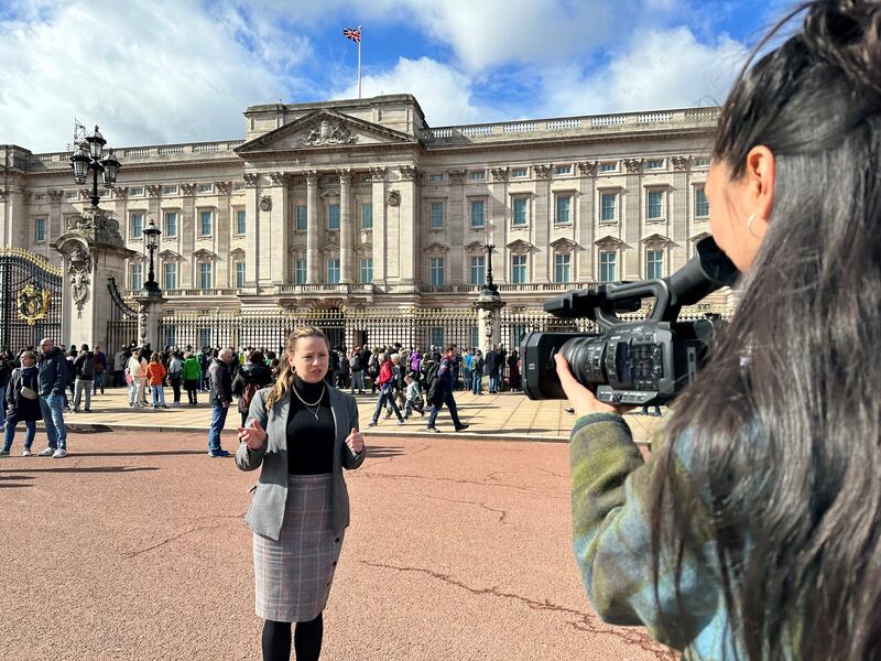 Reporter Laura O'Callaghan and multimedia journalist Amy McConaghy outside Buckingham Palace in London. The National