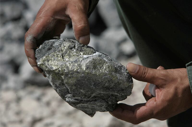 A worker holds a rock at Al Amar gold mine that lies south-west of Saudi capital Riyadh. Reuters