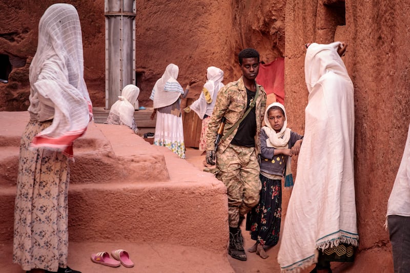Amhara Fano militia fighter Eshete Zewudru, third right, visits a church in Lalibela on December 7.  AFP
