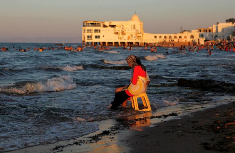 People enjoy the beach on a hot day in Tunis, Tunisia. Reuters