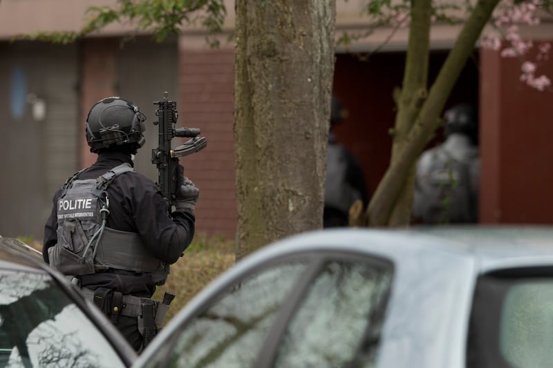Dutch counter-terrorism police prepare to enter a house after a shooting incident in Utrecht. AP