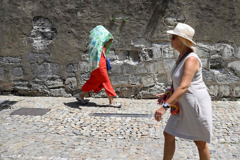 A woman covers herself with a scarf in Avignon, southern France. AFP