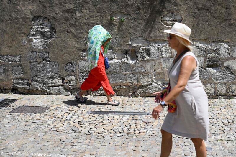 A woman covers herself with a scarf in Avignon, southern France. AFP