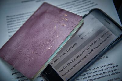 FOLKESTONE, ENGLAND - DECEMBER 28: A negative COVID-19 test result is displayed on a phone for travel to mainland France on December 28, 2020 in Folkestone, England. Last week, both freight and passenger travel from the UK to France were suspended due to concerns of a new COVID-19 virus variant prevalent in England. Travellers are now required to show a recent negative COVID-19 test result prior to crossing. (Photo by Kiran Ridley/Getty Images)