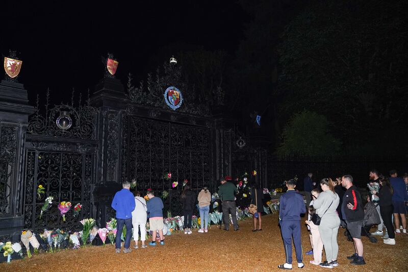 People pay their respects at the gate of Sandringham House in Norfolk. PA