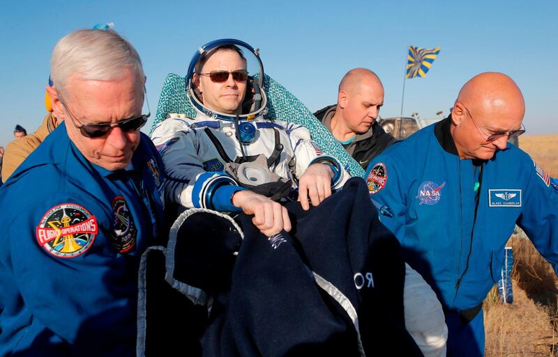 NASA specialists carry US astronaut Nick Hague. AP Photo