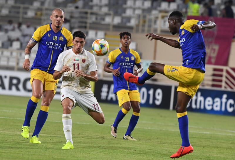 Al Wahda's Tagliabue fights for the ball with Al Nassr's Omar Hawsawi. AFP