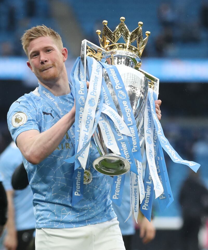 Manchester City's Kevin De Bruyne celebrates with the Premier League trophy after trouncing Everton on the final day of the 2020/21 season. Reuters