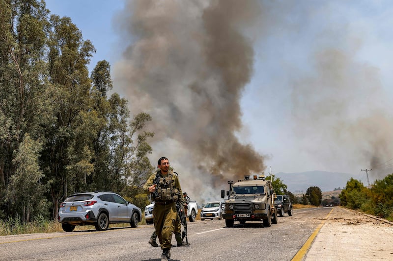 Smoke rises after rockets fired from south Lebanon land near Kfar Szold in the Upper Galilee in northern Israel.AFP