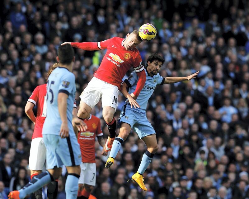 Manchester City's Jesus Navas (R) jumps for the ball with Manchester United's Wayne Rooney (2nd R) during their English Premier League soccer match at the Etihad Stadium in Manchester, northern England November 2, 2014.     REUTERS/Andrew Yates (BRITAIN - Tags: SPORT SOCCER TPX IMAGES OF THE DAY) NO USE WITH UNAUTHORIZED AUDIO, VIDEO, DATA, FIXTURE LISTS, CLUB/LEAGUE LOGOS OR "LIVE" SERVICES. ONLINE IN-MATCH USE LIMITED TO 45 IMAGES, NO VIDEO EMULATION. NO USE IN BETTING, GAMES OR SINGLE CLUB/LEAGUE/PLAYER PUBLICATIONS. FOR EDITORIAL USE ONLY. NOT FOR SALE FOR MARKETING OR ADVERTISING CAMPAIGNS