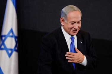 Likud party leader Benjamin Netanyahu gestures to his supporters at his party headquarters during Israel's general election in Jerusalem, November 2, 2022.  REUTERS / Ammar Awad