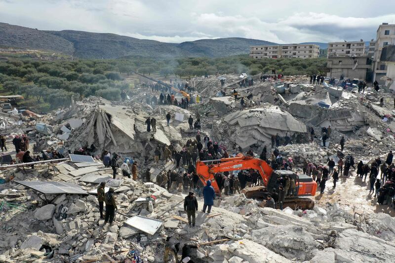 Residents search for survivors amid the rubble of collapsed buildings in the village of Besnia, in Syria's north-western Idlib province. AFP
