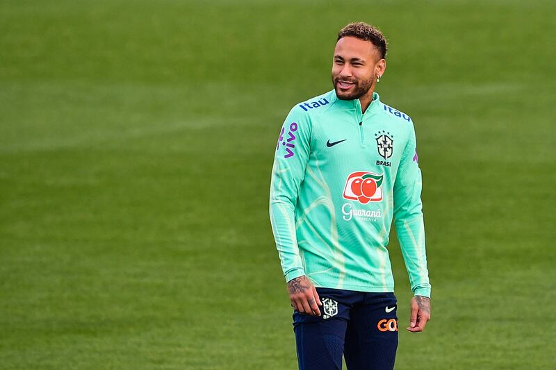 Neymar smiles during the training session. AFP