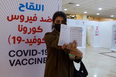 A woman displays her Covid-19 vaccine certificate at the Bahrain International Exhibition and Convention Centre in the capital Manama. AFP