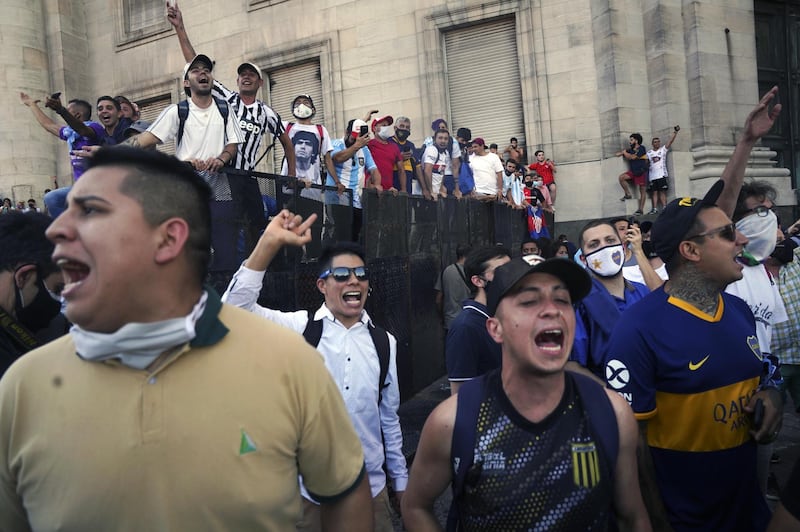 People react during a tribute to the late Argentine great Diego Maradona, outside the Casa Rosada presidential palace in Buenos Aires. Bloomberg