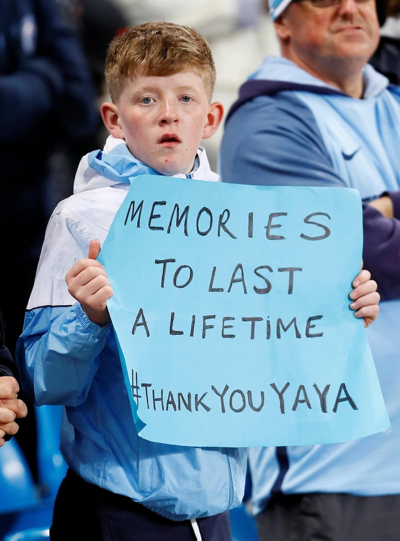 A young Manchester City fan holds up a banner in reference to Yaya Toure. Jason Cairnduff / Reuters