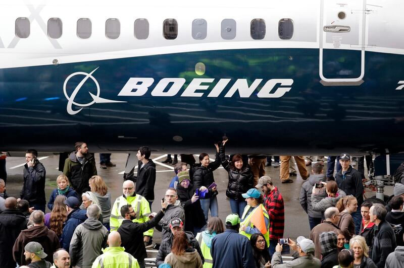 FILE- In this Feb. 5, 2018, file photo a Boeing 737 MAX 7, the newest version of Boeing's fastest-selling airplane, is displayed during a debut for employees and media of the new jet in Renton, Wash.  Boeing says it's providing $100 million over several years to help families and communities affected by two crashes of its 737 Max plane that killed 346 people. The company said Wednesday, July 3, 2019,  that some of the money will go toward living expenses and to cover hardship suffered by the families of dead passengers.  (AP Photo/Elaine Thompson, File)