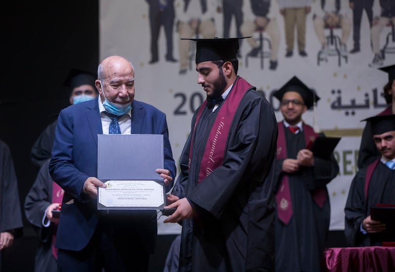 Ajman, United Arab Emirates - Ibrahim Barakeh, owner of Al Shola giving the diploma at the Al Shola American School first in-person graduation for 12 graders.  Leslie Pableo for The National for Amir's story