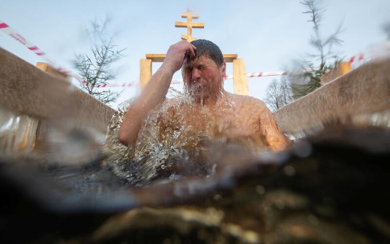 A man takes a dip in icy water to celebrate Orthodox Epiphany in the town of Staraya Russa in Novgorod, Russia. Reuters