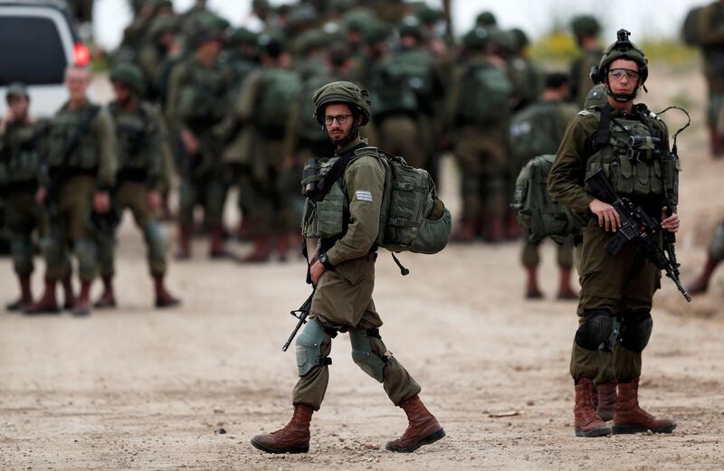 Israeli soldiers make their way to their positions at the Israeli border with Gaza next to the security fence on March 29, 2019. EPA