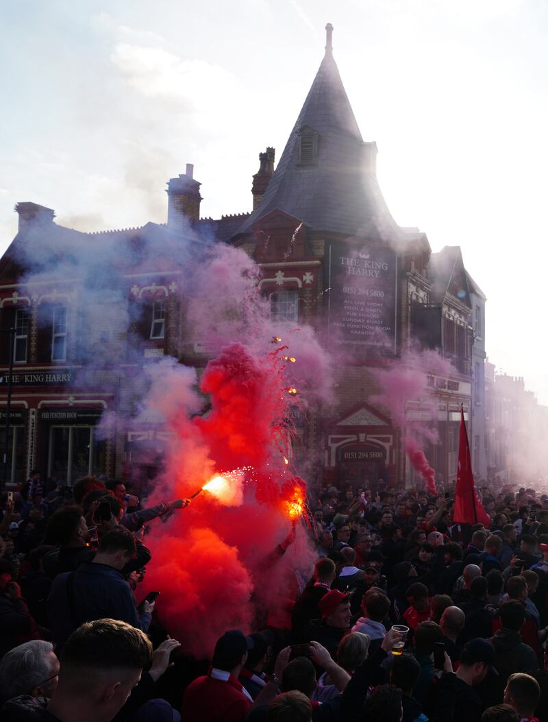 Liverpool fans greet their team bus. PA