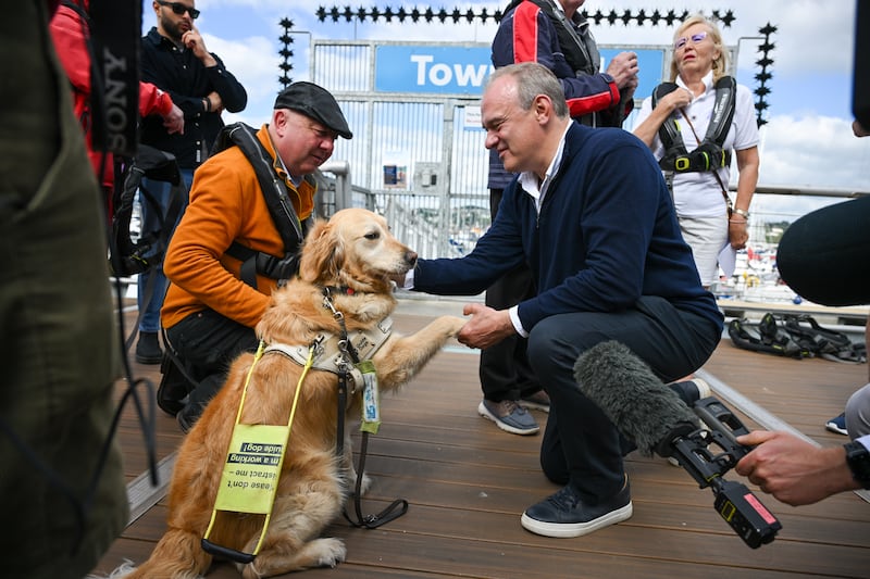 Mr Davey meets Steve Darling, Liberal Democrat candidate for Torbay and his guide dog Jennie at Torquay Harbour. Getty Images