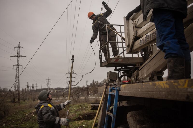 Electricity workers fix a damaged power line in Kherson. Ukraine's energy infrastructure has been increasingly struck by Russian missiles and drones since October 2023. Getty Images
