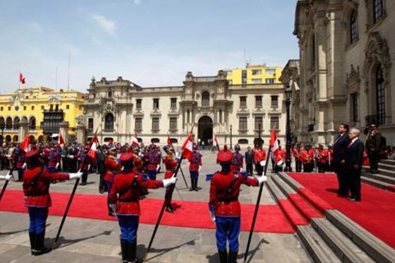 A guard of honour salutes the Peruvian president Alan Garcia, left, and his visiting Chilean counterpart, Sebastian Pinera, as Peru’s national anthem is played during a state ceremony in Lima.