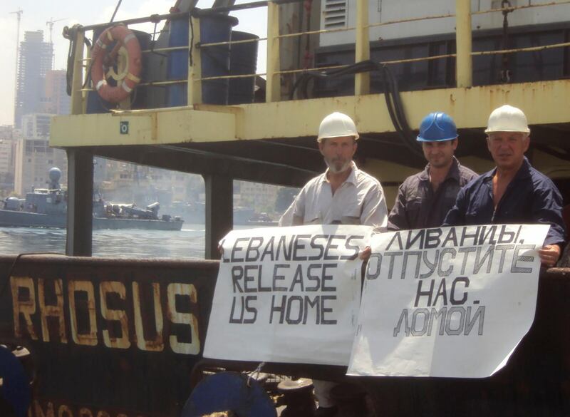 Captain Boris Prokoshev and crew members demand their release from the arrested cargo vessel Rhosus in the port of Beirut in the summer of 2014. Boris Musinchak / Reuters