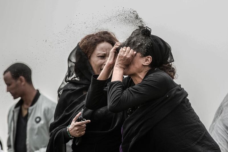 A photo by Mulugeta Ayene shows a relative of a victim of the Ethiopian Airlines Flight ET302 plane crash throwing dirt in her face as she grieves at the crash site, near Addis Ababa, Ethiopia, on March 14, 2019. It won first prize in the Spot News Stories category. Mulugeta Ayene / AP Photo