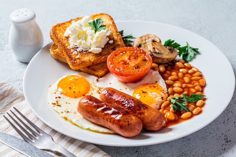 Full English breakfasts traditionally include eggs, sausages, bacon, baked beans, tomatoes, mushrooms, toast and a hot tea. Getty Images