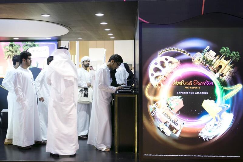 Visitors at Dubai Parks stand at the National Career Exhibition at Sharjah Expo Centre. Reem Mohammed / The National