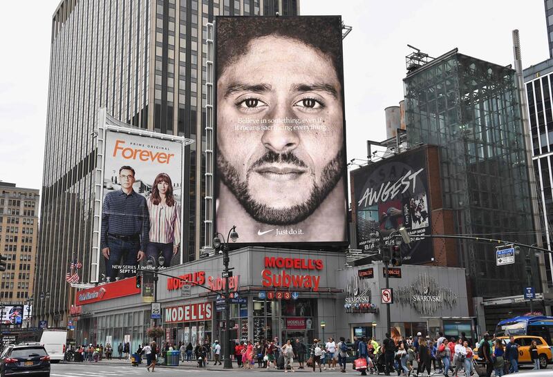 A Nike Ad featuring American football quarterback  Colin Kaepernick is on diplay September 8, 2018 in New York City. - Nike's new ad campaign featuring Kaepernick, the American football player turned activist against police violence, takes a strong stance on a divisive issue which could score points with millennials but risks alienating conservative customers. The ads prompted immediate calls for Nike boycotts over Kaepernick, who has been castigated by US President Donald Trump and other conservatives over his kneeling protests during the playing of the US national anthem. (Photo by Angela Weiss / AFP)