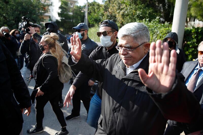 Golden Dawn party leader Nikos Michaloliakos waves as he leaves his residence in Athens, Thursday, Oct. 22, 2020.A court has sentenced Michaloliakos and the leadership of Greece's extreme-right Golden Dawn party to 13 years in prison, imposing the near-maximum penalty for running a criminal organization blamed for numerous violent hate crimes. The landmark ruling follows a five-year trial of dozens of top officials, members, and supporters of the organization founded as a Neo-Nazi group in the 1980s, that rose to become Greece's third-largest political party during a major financial crisis in the previous decade. (AP Photo/Thanassis Stavrakis)