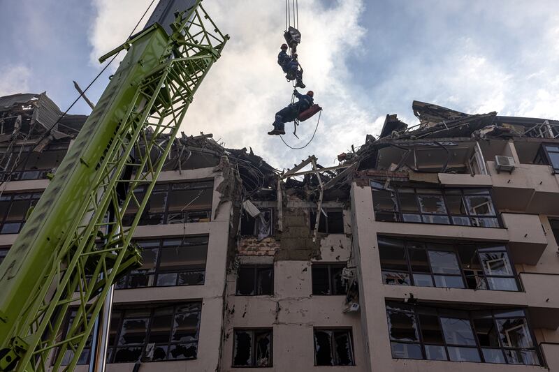 Rescuers in action next to a damaged residential building following Russian airstrikes in the Shevchenkivskyi district of Kyiv, Ukraine, on June 26. EPA