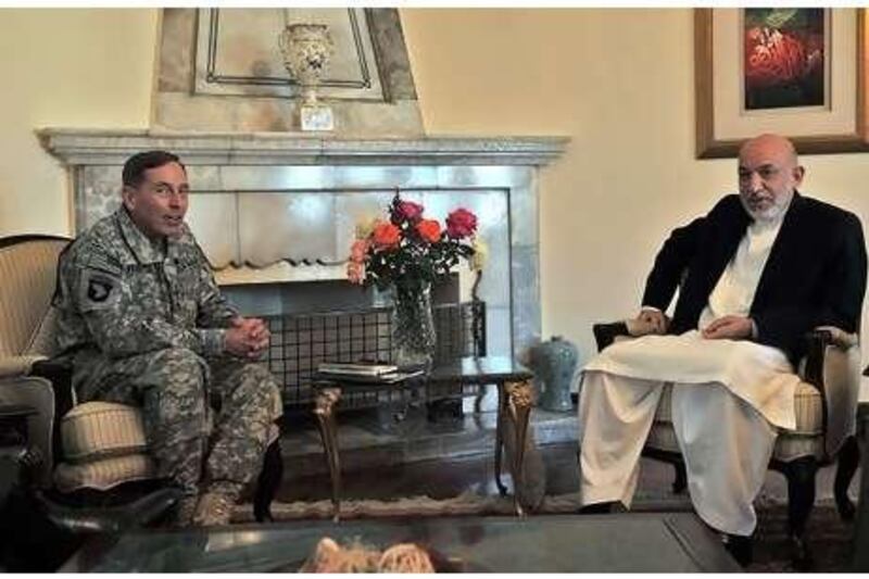 Gen David Petraeus with Hamid Karzai, the president of Afghanistan, in Kabul yesterday.