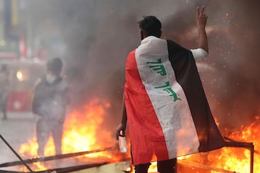 Anti-government protesters set fire and close streets during ongoing protests in Baghdad, Iraq. AP Photo