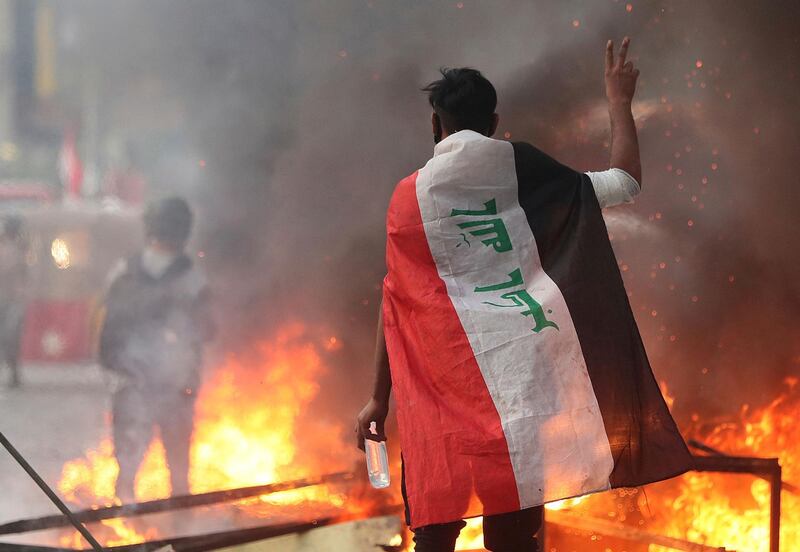 Anti-government protesters set fire and close streets during ongoing protests in Baghdad, Iraq, in central Baghdad, Iraq, Saturday, Nov. 9, 2019. Mass protests erupted in Baghdad and across southern Iraq last month, calling for the overhaul of the political system established after the 2003 U.S.-led invasion.  (AP Photo/Hadi Mizban)