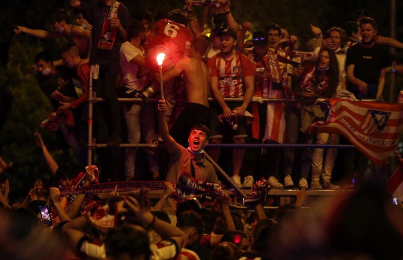 Atletico Madrid fans celebrate La Liga title of their team at Neptuno Fountain. EPA