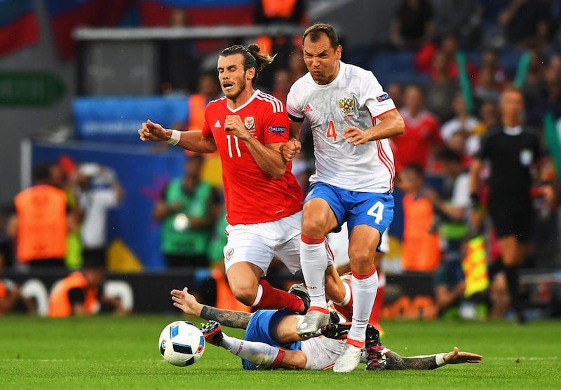 Gareth Bale of Wales is tackled by Pavel Mamaev of Russia during the UEFA EURO 2016 Group B match between Russia and Wales at Stadium Municipal on June 20, 2016 in Toulouse, France. (Photo by Stu Forster/Getty Images)
