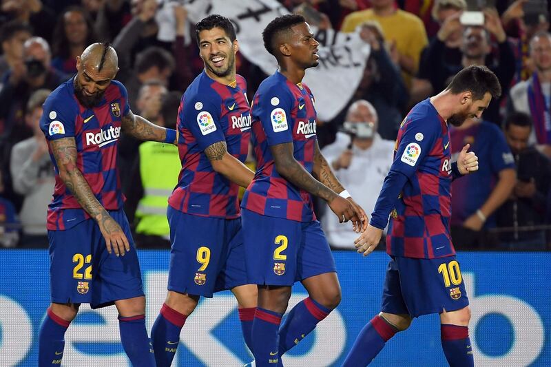 (L to R) Barcelona's Chilean midfielder Arturo Vidal, Barcelona's Uruguayan forward Luis Suarez and Barcelona's Portuguese defender Nelson Semedo celebrate Barcelona's Argentine forward Lionel Messi's second goal during the Spanish league football match between FC Barcelona and Real Valladolid FC at the Camp Nou stadium in Barcelona on October 29, 2019. / AFP / LLUIS GENE
