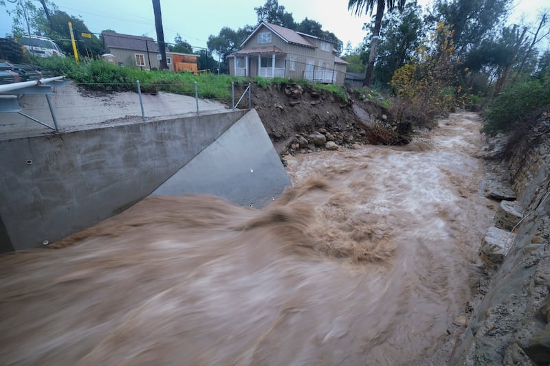 Water rages along Montecito Creek in in Montecito. AP
