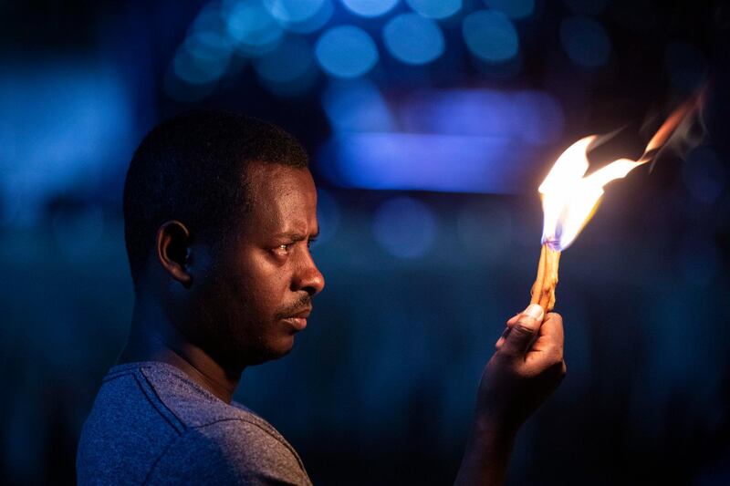 A man holds a candle in tribute at a memorial service for the crew of Ethiopian Airlines Flight ET302, held at the Ethiopian Pilots Association in the capital Addis Ababa.  AP