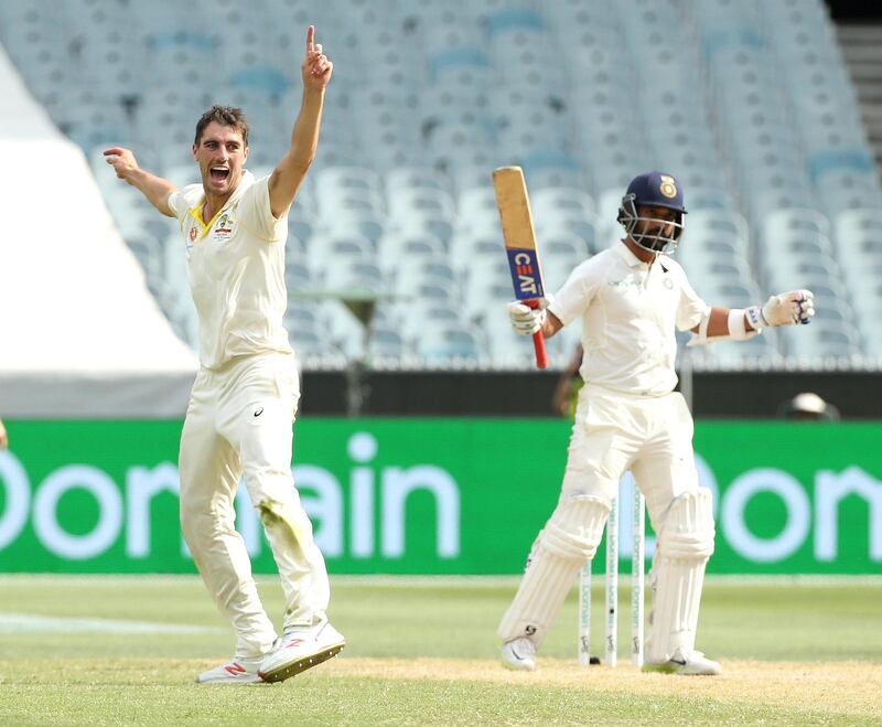 Australia's Pat Cummins (L) celebrates the wicket of India's Ajinkya Rahane on day three of the third test match between Australia and India at the MCG in Melbourne, Australia. Reuters