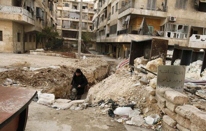 A Syrian rebel runs through a trench in Aleppo's Bustan Al Qasr neighbourhood to avoid snipers, as the conflict continues. Peace talks scheduled next month have raised hopes that a solution can be found "for the silent majority" of Syrians. Molhem Baraket / Reuters

