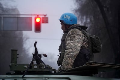 A Kazakhstan soldier patrol a street after clashes in Almaty, Kazakhstan, Thursday, Jan.  6, 2022.  Kazakhstan's president authorized security forces on Friday to shoot to kill those participating in unrest, opening the door for a dramatic escalation in a crackdown on anti-government protests that have turned violent.  The Central Asian nation this week experienced its worst street protests since gaining independence from the Soviet Union three decades ago, and dozens have been killed in the tumult. (Vladimir Tretyakov/NUR. KZ via AP)