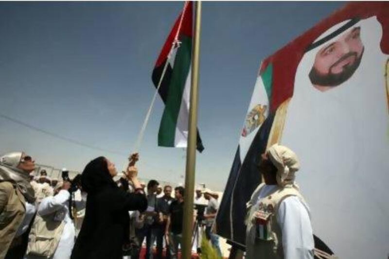 Sheikha Lubna Al Qasimi raises the Emirati flag to inaugurate the Emirati-Jordanian camp for Syrian refugees in the Mreijeb al Fhoud area of in east Jordan yesterday. Salah Malkawi for The National