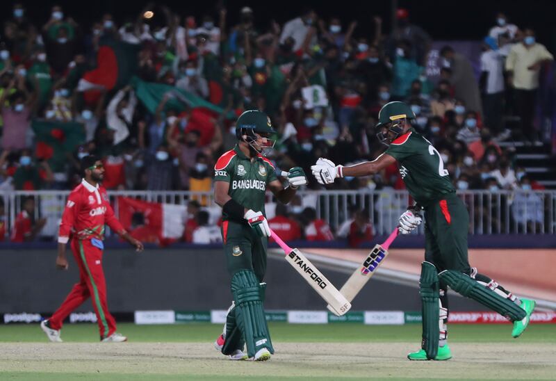 Bangladesh's Afif Hossain, left, with teammate Mohammad Naim during the Twenty20 World Cup first round match against Oman in Muscat. AP