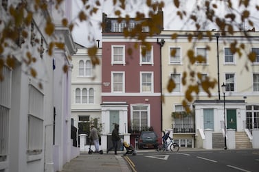 A pedestrian walks past residential houses in Notting Hill in London. UK lenders approved 104,969 mortgages in November – the highest level since the financial crisis. Bloomberg